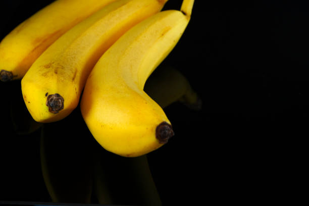 istock Bananas isolated on black background close-up view, copy space 1991519106