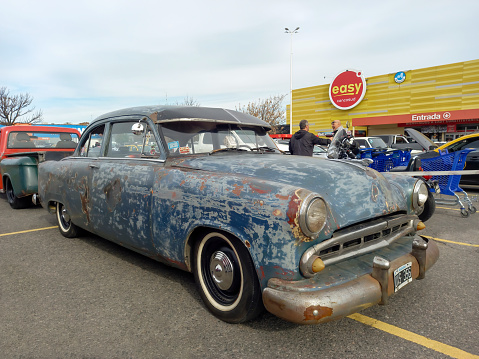 Buenos Aires, Argentina - Jun 4, 2023: An old aged unpainted 1950s Dodge Coronet coupe at a classic car show in a parking lot.