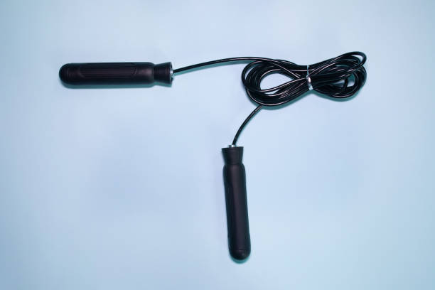 istock Skipping rope with black handles on the blue background. 1991657365