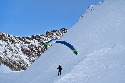 09 September 2020, Babadag, Oludeniz, Turkey: Many paragliding adventurers takeoff in tandem with instructor after a short training session for recreational flight and descent to the sea