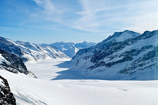 Aerial view of glaciated mountains and blue sky