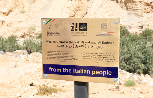 Amman, Jordan, October 06, 2023 : Explanatory sign at the beginning of the path of the gorge Wadi Al Ghuwayr or An Nakhil and the wadi Al Dathneh near Amman in Jordan