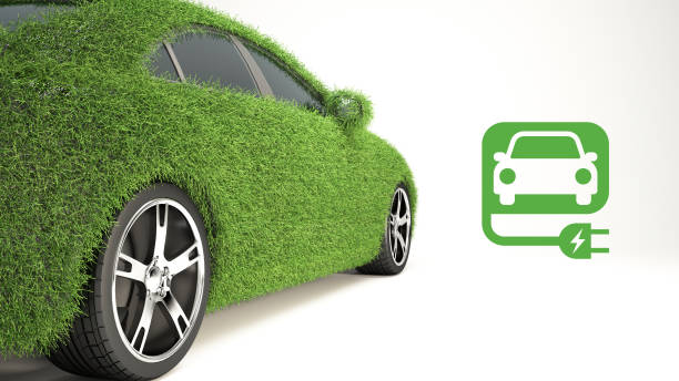 istock EV car covered with realistic grass isolated on white. Electric vehicle charging station. 1991763535