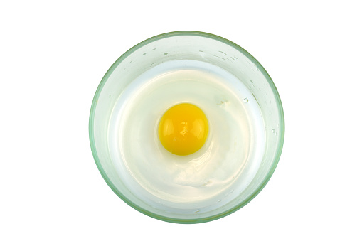 top view of chicken egg yolk in glass bowl