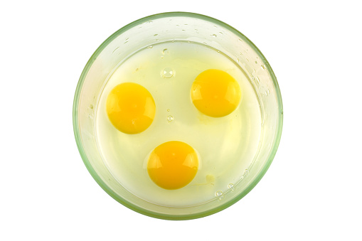 top view of chicken egg yolk in glass bowl