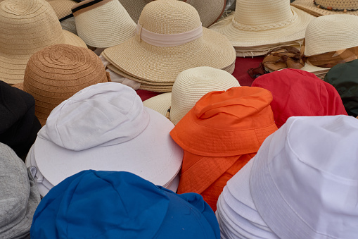 Hats of different colors crowded at a stall at the Sabaris fair held every Monday in Bayonne, Galicia, Spain