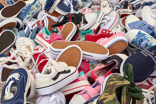 Sabaris, Bayonne, Spain; July,19,2021:Sports shoes of different colors piled up on a stall at the Sabaris Fair