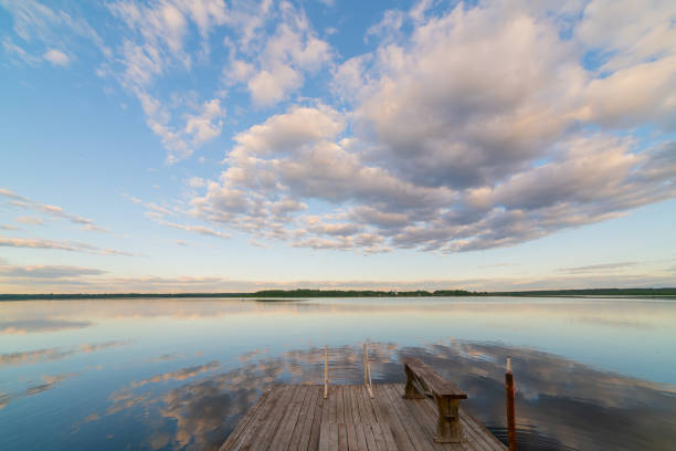istock White clouds in the blue sky over the river. 1991836938