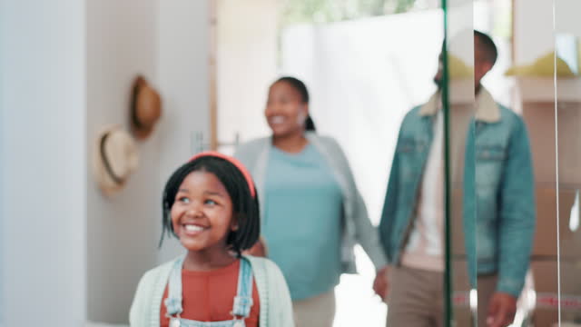 Happy black family, door and moving in new home for property, investment or shelter together. African mother, father and child, kid or daughter smile for house, real estate or relocation at entrance