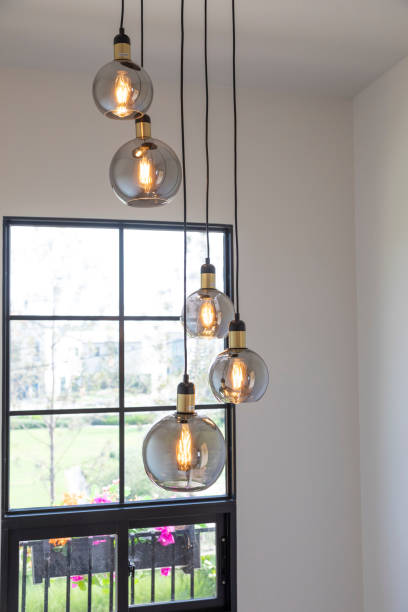 istock Modern round glass chandelier inside home staircase interior. 1991838520