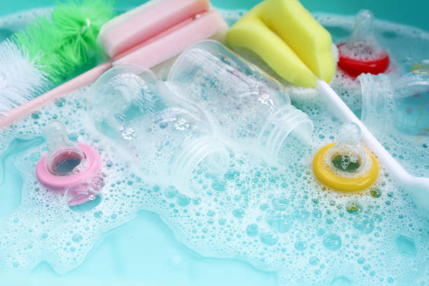 istock Wash baby bottles in plastic blue basin 1991846340