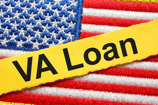USA flag and strip of paper with an inscription VA loan.