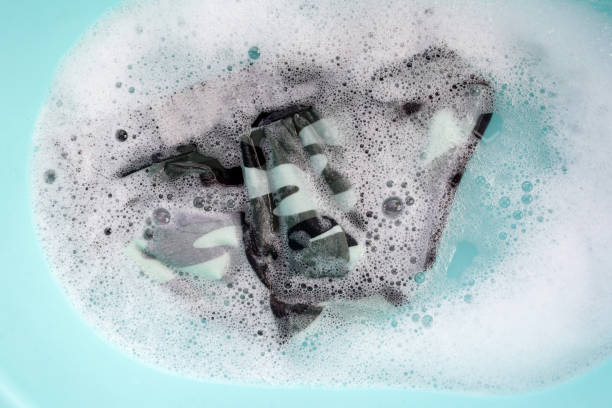 istock Men underwear soaked in water dissolved detergent with white foam bubble. Laundry concept 1991869742