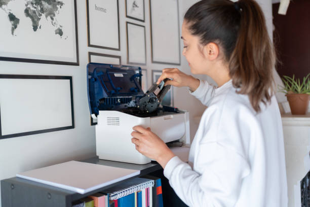 istock Woman Change The Printer Toner At Home 1991875512