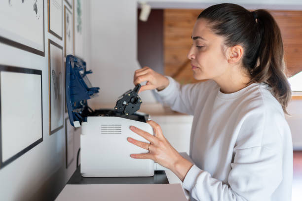 istock Woman Change The Printer Toner At Home 1991879569