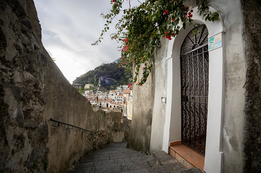 Amalfi, Amalfi coast, Salerno, Italy.\ntypical narrow street, alley with white walls and steps