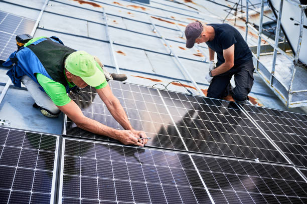 istock Workers building solar panel system on roof of house. Men installing photovoltaic solar module 1991889748