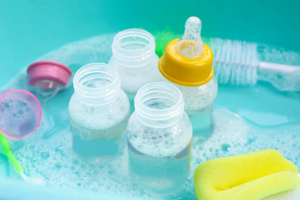 istock Wash baby bottles in plastic blue basin 1991890729