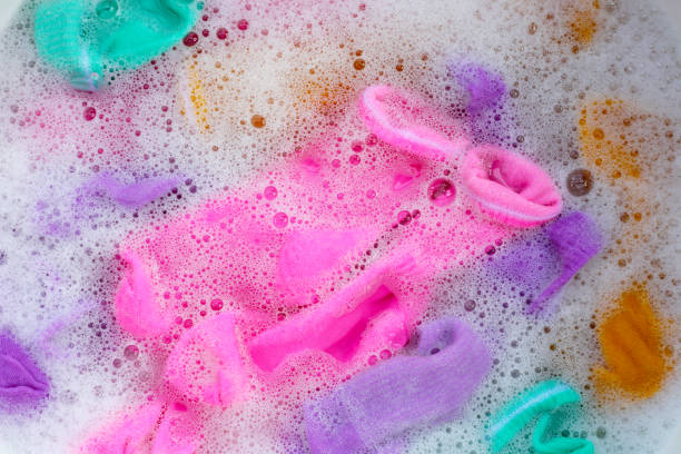 istock Dirty socks soaked in water, dissolving detergent in basin. 1991914056
