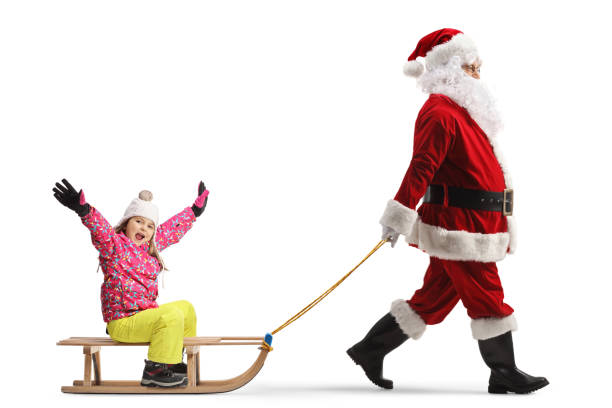 istock Santa clus pulling a wooden sled with a happy litttle girl 1991917690