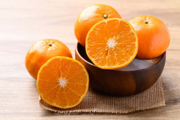 istock Mandarin orange fruit in wooden bowl, Tropical fruit 1991938569