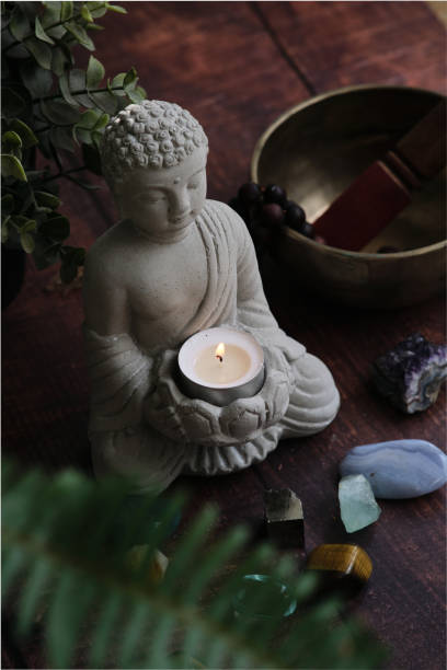 istock stone statue of buddha with a candle 1991939091