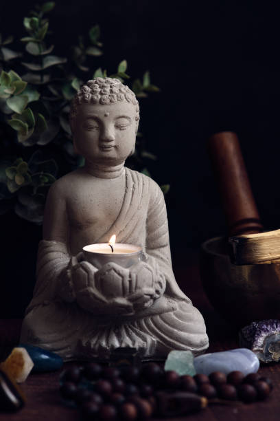istock stone statue of buddha with a candle 1991939121