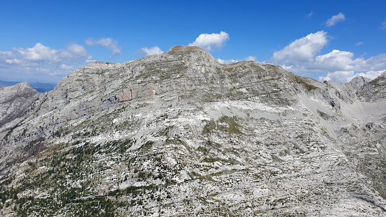 Italian mountains near the Langkofel Group, and green meadows on a sunny cloudless day. Alpine road surrounded by mountains.