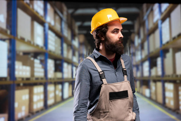 istock Packaging employee verifying merchandise stock on industrial racks 1991943956