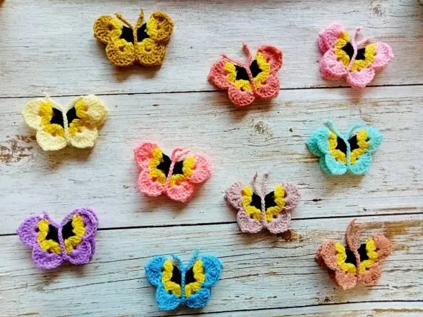 Photo of Crochet butterfly muticolor handmade craft diy, buterfly for illustrations of handicrafts, background texture