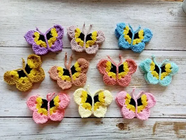 Photo of Crochet butterfly muticolor handmade craft diy, buterfly for illustrations of handicrafts, background texture