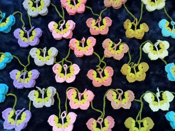 Photo of Crochet butterfly muticolor handmade craft diy, buterfly for illustrations of handicrafts, background texture