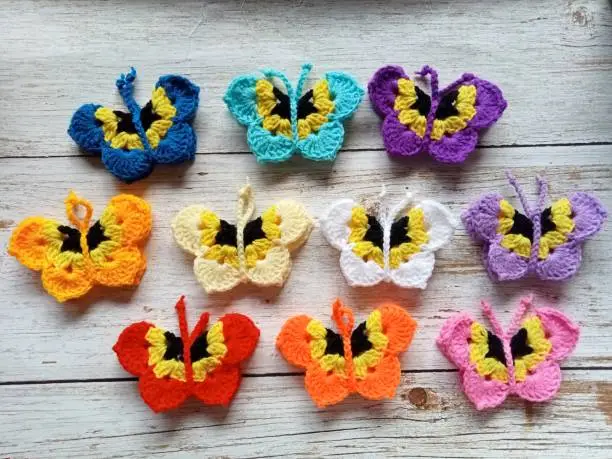 Photo of Crochet butterfly muticolor handmade craft diy, buterfly for illustrations of handicrafts, background texture