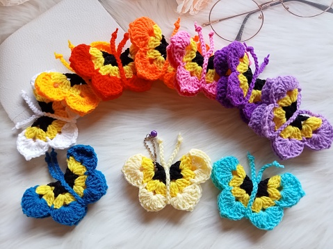 Crochet butterfly muticolor handmade craft diy, buterfly for illustrations of handicrafts, background texture