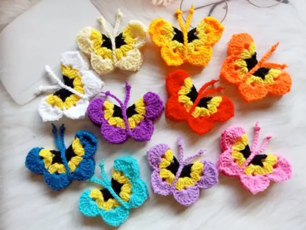 Photo of Crochet butterfly muticolor handmade craft diy, buterfly for illustrations of handicrafts, background texture