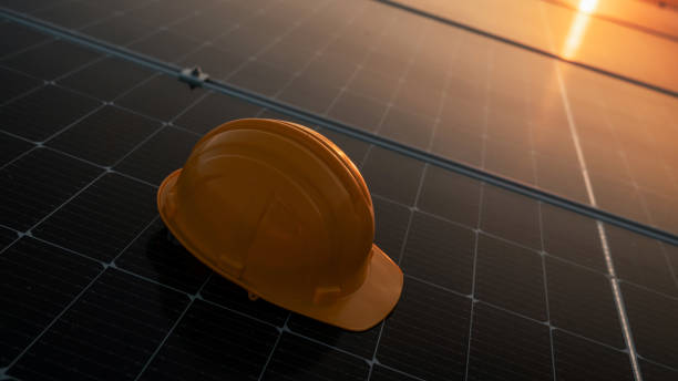 yellow engineer hard safety helmet hat on solar cell panel. clean energy concept. - fuel cell solar panel solar power station control panel fotografías e imágenes de stock