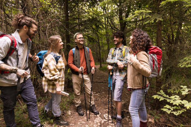 istock Young happy hikers talking on a break in forest. 1991960638