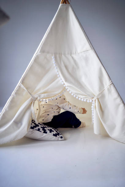 istock toddler playing in a tent in a minimalist style 1991975982