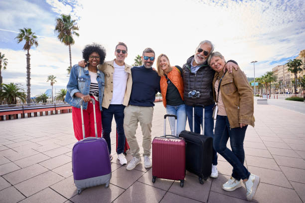 istock Portrait group mature tourist friends embraced in affectionate attitude looking smiling camera. 1991978118