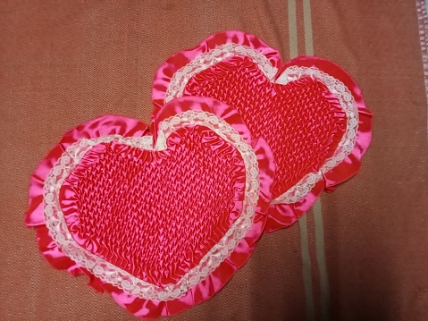 Pillow with heart and floral pattern on the sofa