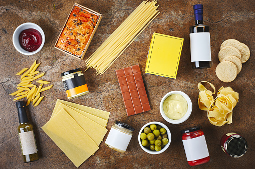 Cooking, ingredients and above of pasta in kitchen with noodles, sauce and jar for meal preparation. Food, dinner and top view of counter with Italian cuisine for wellness, nutrition and healthy diet