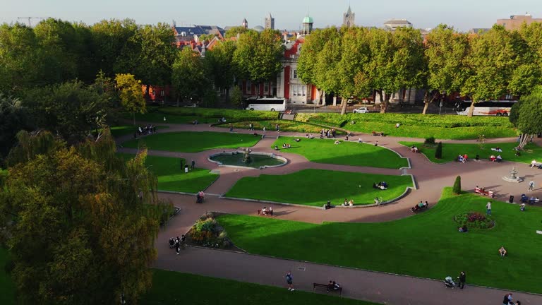 Aerial view of cathedral and park from Saint Patrick's Park-Dublin, Aerial view of historic St. Patrick's Cathedral in the heart of Ireland, Christ Church Cathedral, Aerial view of people walking in saint Patrick park, Public park fountain