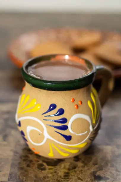 Photo of Traditional Mexican cup with hot chocolate drink. champurrado