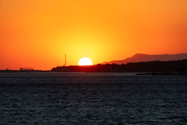 istock Hiding behind an island at sea. Sunset 1992032910