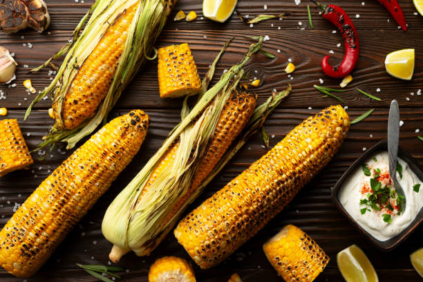 istock Grilled corn on the cob on kitchen wooden table flat lay background 1992033445