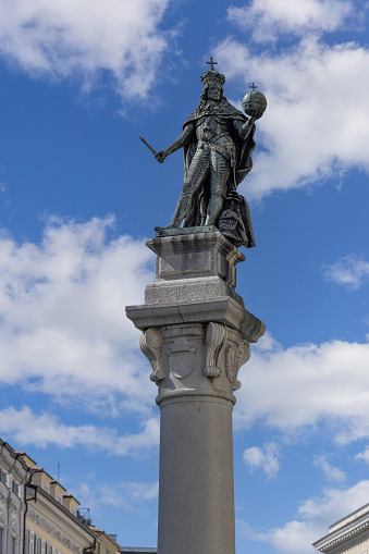 Trieste, Italy - September 26, 2023:  Statue of Leopold I, Holy Roman Emperor and Habsburg Emperor. Column is located on Stock Exchange Square