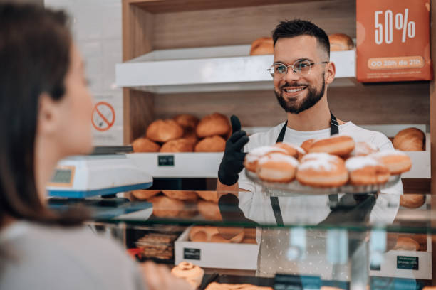 istock Woman delighted by donut selection 1992036142