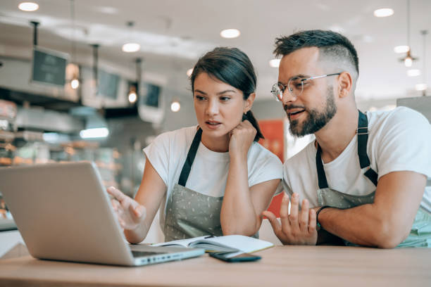 istock Colleagues jointly engaged with laptop 1992037171