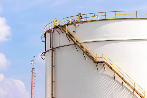 White fuel oil storage tank with blue sky background, Storage tank important infrastructure for oil and gas, The storage tank place to receive and store oil at fuel terminal, Oil and Gas storage tank.