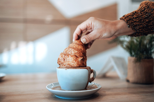 In an elegant close-up, coffee and croissant take center stage, embodying the essence of a serene morning